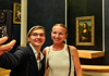A group of tourists in the Louvre Museum and learning about Liberty Leading the People while on tour with The Tour Guy.