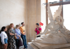 A tour guide in the Louvre speaking with a group of tourists on tour with The Tour Guy.