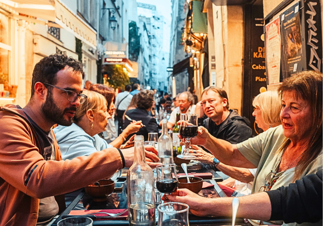Group eating beef bourguignon in during a Paris food tour