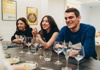 Women pouring wine into beaker