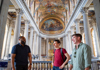 A group of tourists taking a tour in the Hall of Mirrors at Versailles with a guide from The Tour Guy.