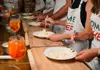 A person mixing pasta in a bowl preparing for dinner
