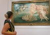 A woman viewing Primavera in the Uffizi Gallery while on tour with The Tour Guy.