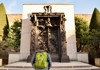 A man looking at the Gates of Hell at the Rodin Museum in Paris.