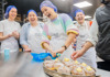 A photo of people baking donuts in a donut baking class while on tour with The Tour Guy.