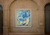 A framed Picasso painting displayed within an arched stone alcove, illuminated by soft lighting.