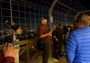 A group of tourists standing on the Eiffel Tower listening to a guide from The Tour Guy.