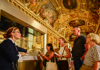 A tour guide in the Louvre Museum speaking about the Raft of Medusa to a group on tour with The Tour Guy.