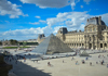 Tourists looking at the French Crown Jewels on display in the Louvre Museum.