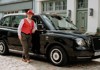 A driver standing next to a traditional London Black Cab.