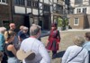 A Tower of London Beefeater speaking with a group of tourists on tour with The Tour Guy.