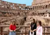 A couple having their picture taken at the Colosseum.