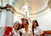 A woman in front of the Statue of David in the Accademia Gallery with her guide from The Tour Guy.