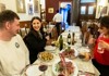 A couple sitting at a table in a restaurant while on a food tour in Florence with their guide from The Tour Guy.