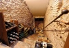 Stairs that lead to a cellar with wine bottles in Rome