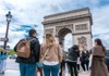 A picture of the Arc de Triomphe in Paris on a sunny day. 