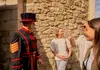A man inside the Tower of London speaking with his guide from The Tour Guy.