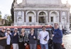 A group of people on a golf cart sipping Prosecco Wine