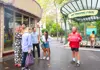 A group of tourists outside the Pierre Herme store in Paris with a guide from The Tour Guy.