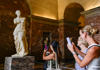 A tourist walking through the Medieval Louvre, the ruins of the Château du Louvre.