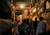 Tour group entering gated section of the Rome catacombs