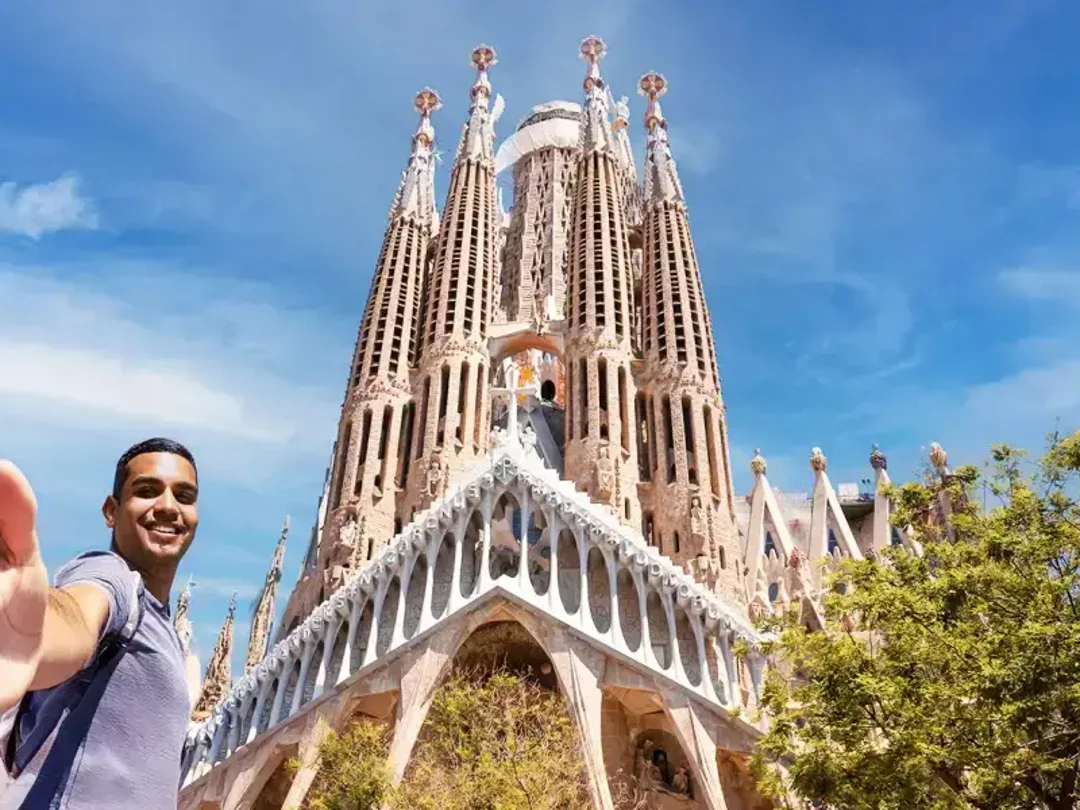 A tourist taking a selfie of the exterior of sagrada familia