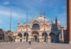 A woman taking a picture of the golden archways inside St. Mark's Basilica.