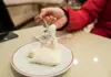 Guest lifting a forkful of stretchy Turkish milk dessert from a plate