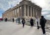 people standing near parthenon under construction