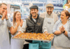 A picture of four people taking a baking class in London while on tour with The Tour Guy.