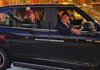 Tourists enjoying a ride inside of a black cab in London.