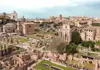 Wide view of the Roman Forum with ancient ruins, columns, and historic buildings