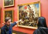 A tour group inside the Louvre Museum with their guide from The Tour Guy.