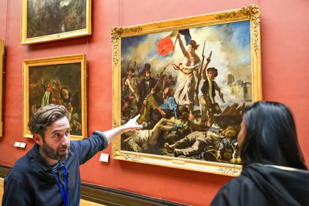 A tour group inside the Louvre Museum with their guide from The Tour Guy.