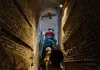 a tourist walking around Domitillas Catacombs in Rome