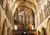 Ornate pipe organ and vaulted ceiling inside a historic Paris church