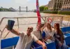 Tour London in One Day SGT LDN 1 Day a group of tourists enjoying the Thames River cruise passing through the Tower Bridge
