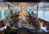 Group of passengers gathered around a table enjoying lunch during a boat excursion.