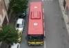Top-down view of a Ferrari Museum shuttle bus traveling along a city road in Modena