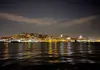 Lisbon waterfront buildings illuminated along the Tagus River