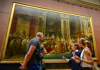 A group of tourists in the Louvre Museum.