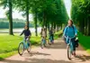 Two men with bicycles in front of Versailles while on tour with The Tour guy.