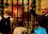 Tour London One Day SGT LDN 1 Day a guide showing the Coronation Chair at Westminster Abbey to a group of tourists