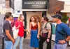 A group of tourists outside of the Abesses metro station in Paris with a guide from The Tour guy.