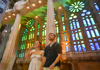 A pair of tourists inside the Sagrada Familia during Golden Hour listening to their guide from The Tour Guy.