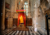 A man looking at golden arches inside Westminster Abbey with his guide from The Tour Guy.