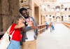 A tourist standing at the entrance to the Arena Floor of the Colosseum while speaking with his guide from The Tour Guy.