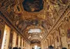 Elaborately decorated gallery with gilded ceilings inside the Louvre Museum