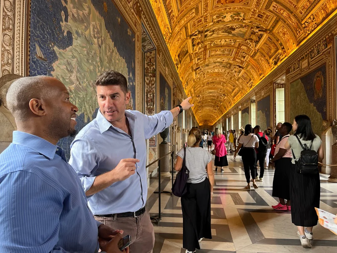 A tourist inside the Vatican Musuems listening to his guide from The Tour Guy.