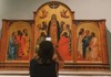 A woman taking a photo of the Pentecost inside the Accademia Gallery while on tour with The Tour Guy.